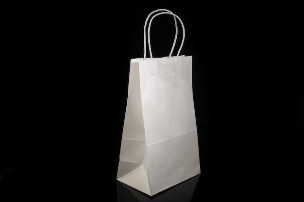 Recyclable craft paper bag for purchases gifts and takeaway food mock up on black background Environmentally friendly than singleuse plastic bags