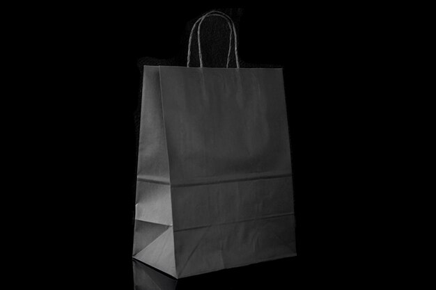 Recyclable craft paper bag for purchases gifts and takeaway food mock up on black background Environmentally friendly than singleuse plastic bags