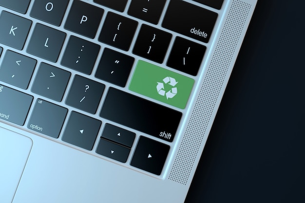 Recycle icon on laptop keyboard. Technology concept