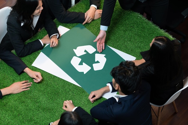 Photo recycle icon on meeting table in office with business people planning eco business investment on waste management as recycle reduce reuse concept for clean ecosystem quaint