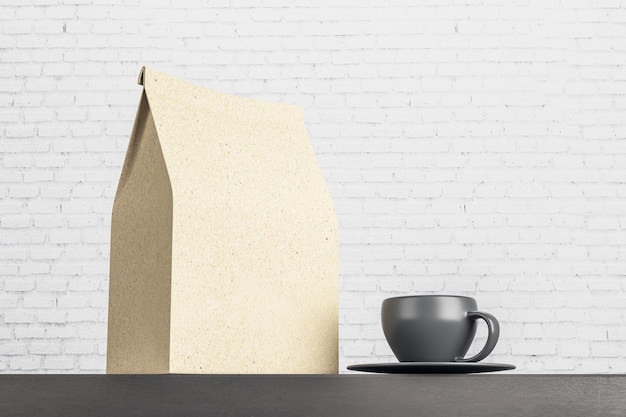 Recycled blank kraft paper tea package with black coffee mug on\
dark wooden surface at light brick wall background mock up