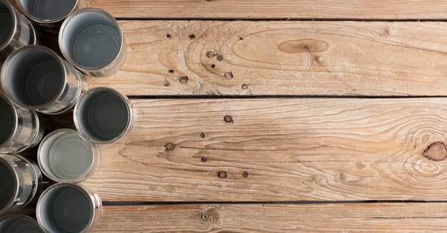 recycled cans reused on a table with a brown background top view space for text