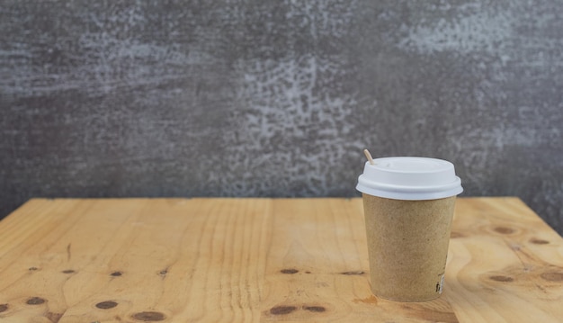 Recycled coffee cup on wooden table