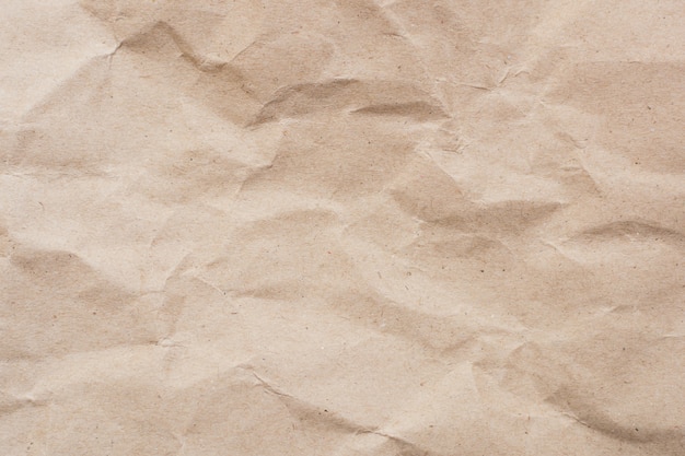 Recycled crumpled light brown paper texture or paper background for design with copy space