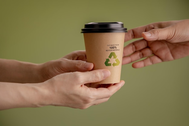 Recycled Packaging Concept Closeup of Barista Giving a Hot Cup of Coffee to customer Zero Waste Materials Environment Care Reuse Renewable for Sustainable Lifestyle