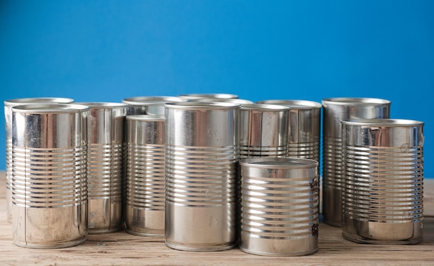 recycling of cans for home on rustic wooden table second life to aluminum can blue background