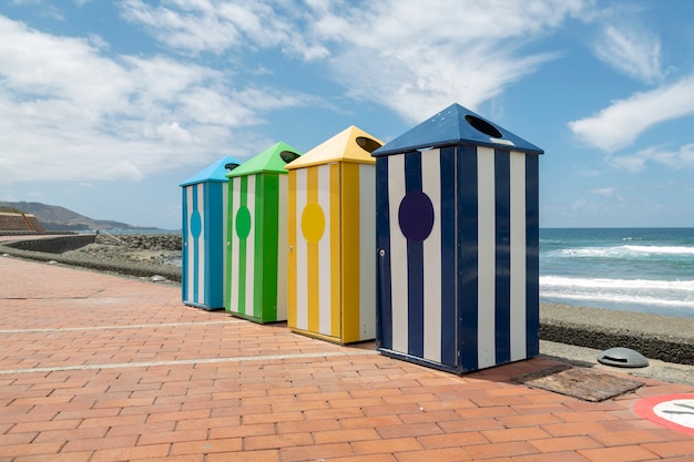 Recycling garbage cans on the promenade on a summer day on the Atlantic beach.