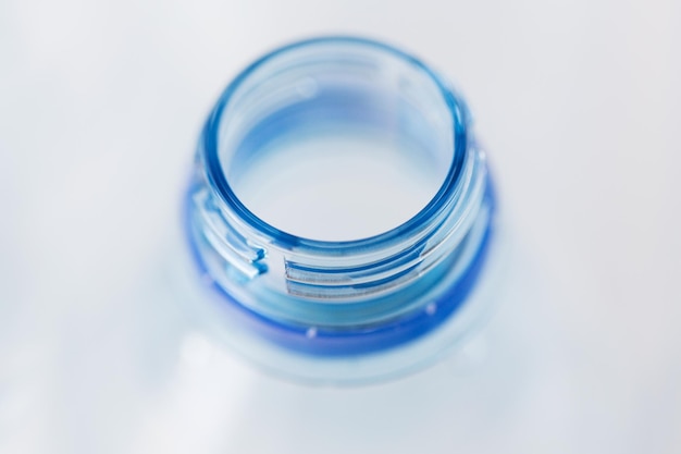 Photo recycling, healthy eating and food storage concept - close up of clean empty used plastic water bottle neck