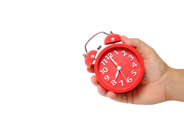 Red alarm clock in hand on a white background