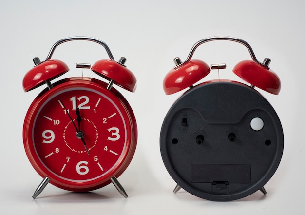 Red alarm clock seen from front and back