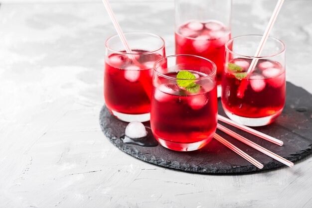 Red alcoholic coctail with ice and mint