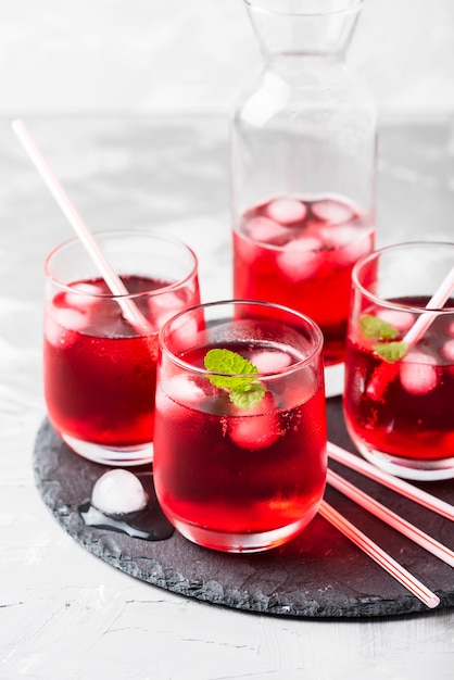 Red alcoholic coctail with ice and mint