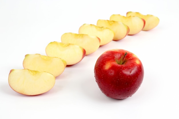 Red apple on a background of cut pieces of apple