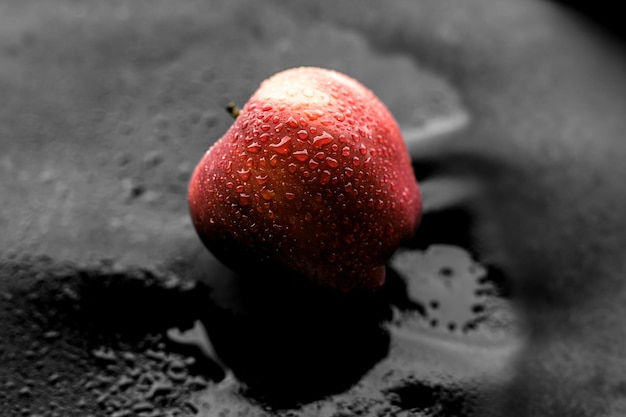 Red apple on black table