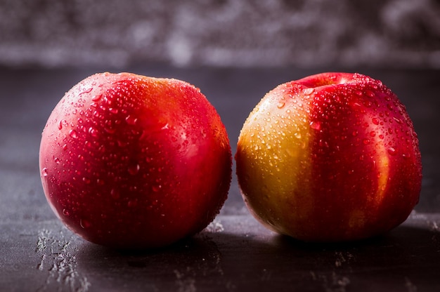 Red apple close up Fresh red apple on a black background texture