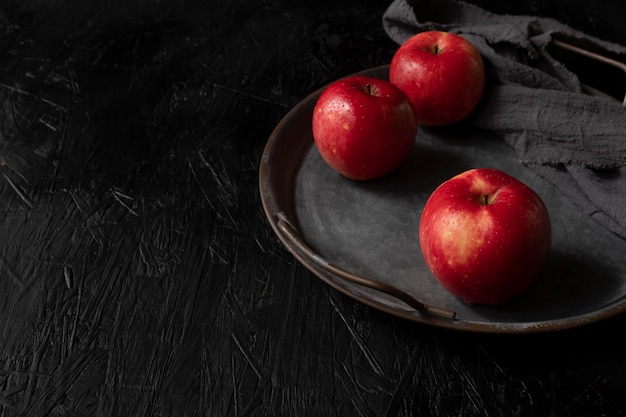 Red apple isolated on the black wooden background