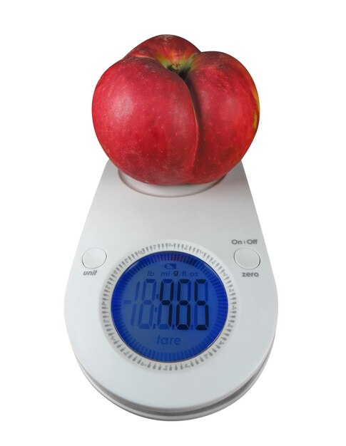 Premium Photo | Red apple on kitchen scales