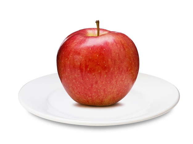 Красное яблоко на тарелке