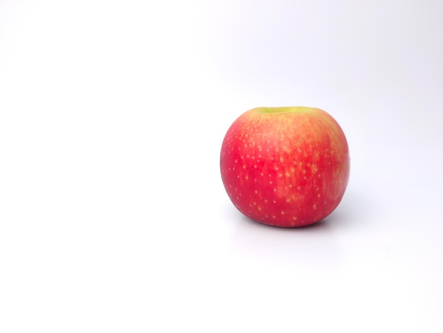 Red apple on a red and white background with copy space