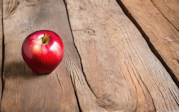 Photo red apple single lying on a wooden table wooden background