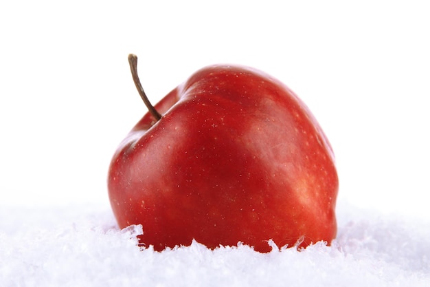 Red apple in snow isolated on white