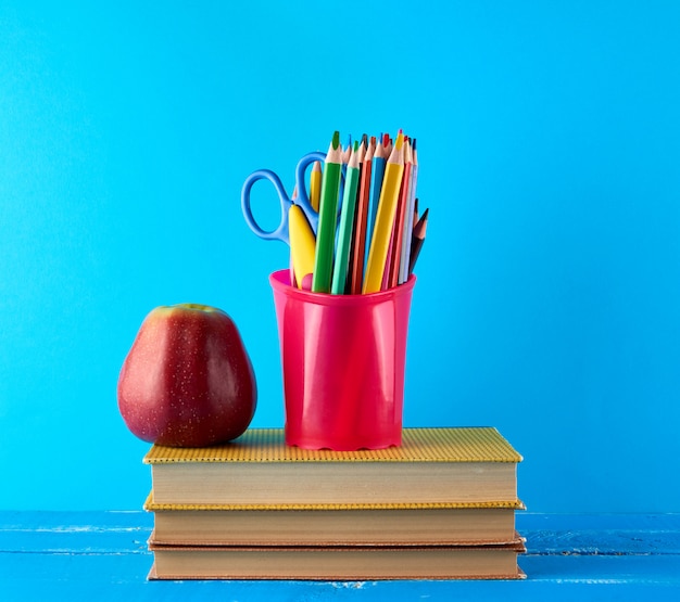 Red apple and stack of books