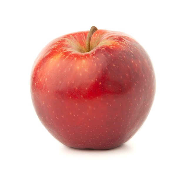 Red apple on a white surface with a shadow.