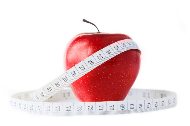 Red apple with centimeter on white background. Isolated on white. Healthy eating