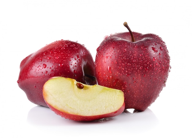 Red apple with water drops on white wall