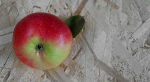 Red apple on a wooden background copy space.