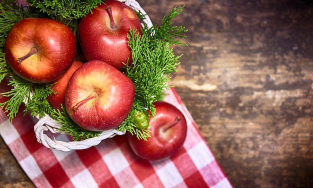 Red apple on the wooden background.