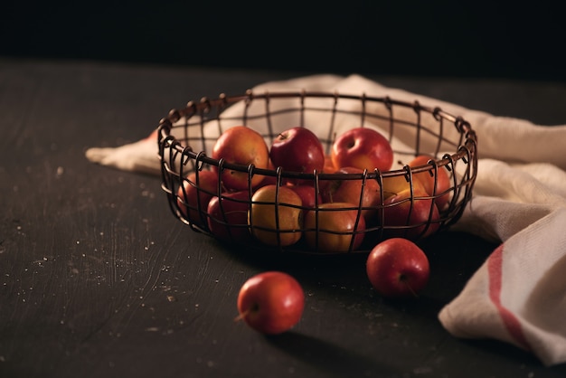 Red apples on basket over black backbground