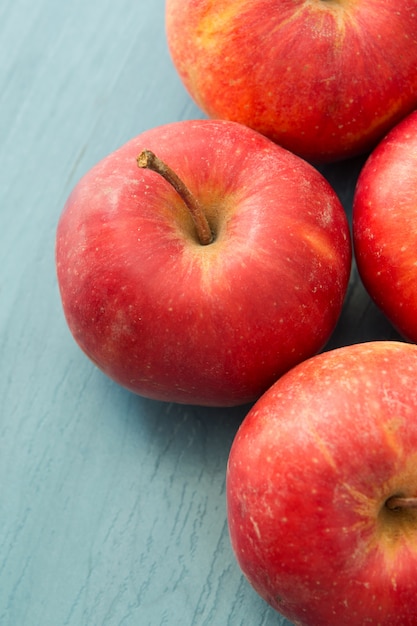 Red apples on a blue table