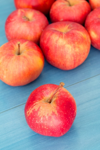 Red apples on a blue table