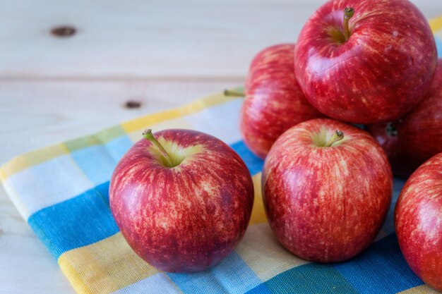 Red apples on colorful napkin.