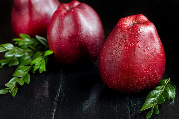 Red apples on a dark, wooden background. Selective focus. Harvesting. Healthy food.