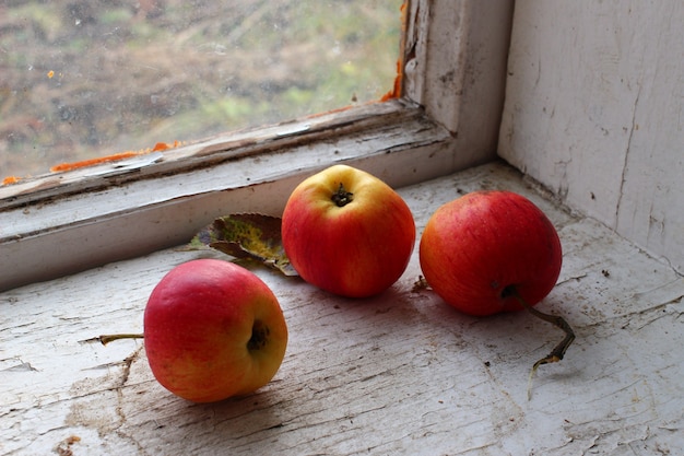 Red apples on an old windowsill