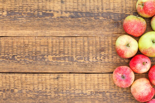 Red apples on old wooden boards. Top view with copy space