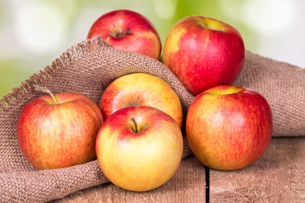 Red apples on an old wooden surface