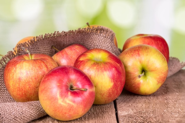 Red apples on an old wooden surface