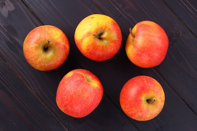 Red apples Pinova on a dark background place  