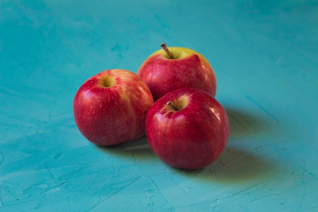 Red apples on a turquoise blue background