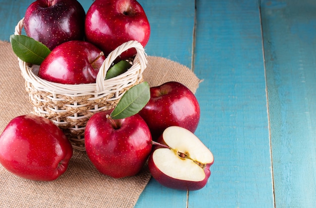 Red apples with leaves on the table