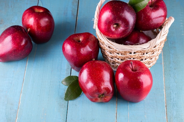 Red apples with leaves on the table