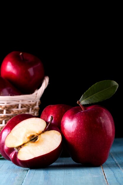 Red apples with leaves on the table