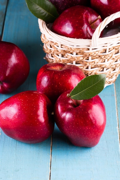 Red apples with leaves on the table