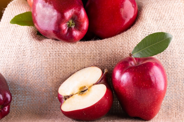 Red apples with leaves on wood