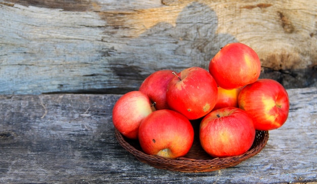 Red apples on the wooden background