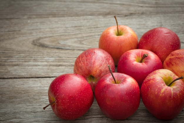 Red apples on a wooden table background