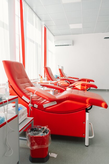 Red armchairs for sitting in donation center